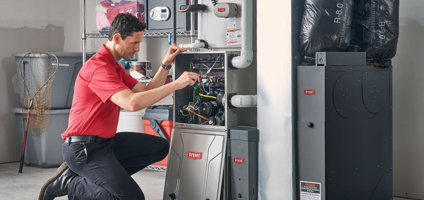 HVAC technician repairing a furnace system
